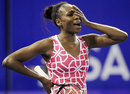Venus Williams reacts to a missed chance against Serena Williams