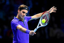 Roger Federer plays a backhand volley