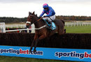 Cue Card takes a fence under Joe Tizzard