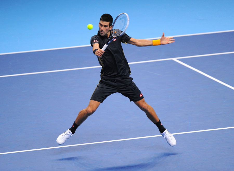 Novak Djokovic plays a backhand volley