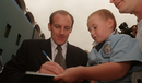 Steve Coppell signs an autograph for a young Manchester City fan