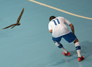 Italy's Saad Assis takes cover as a bird flies over the Huamark Indoor Stadium 