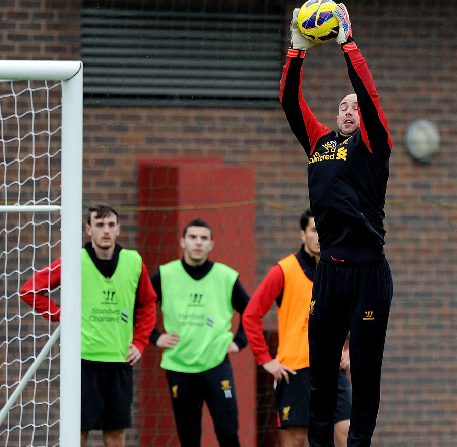 Pepe Reina catches the ball during a training session