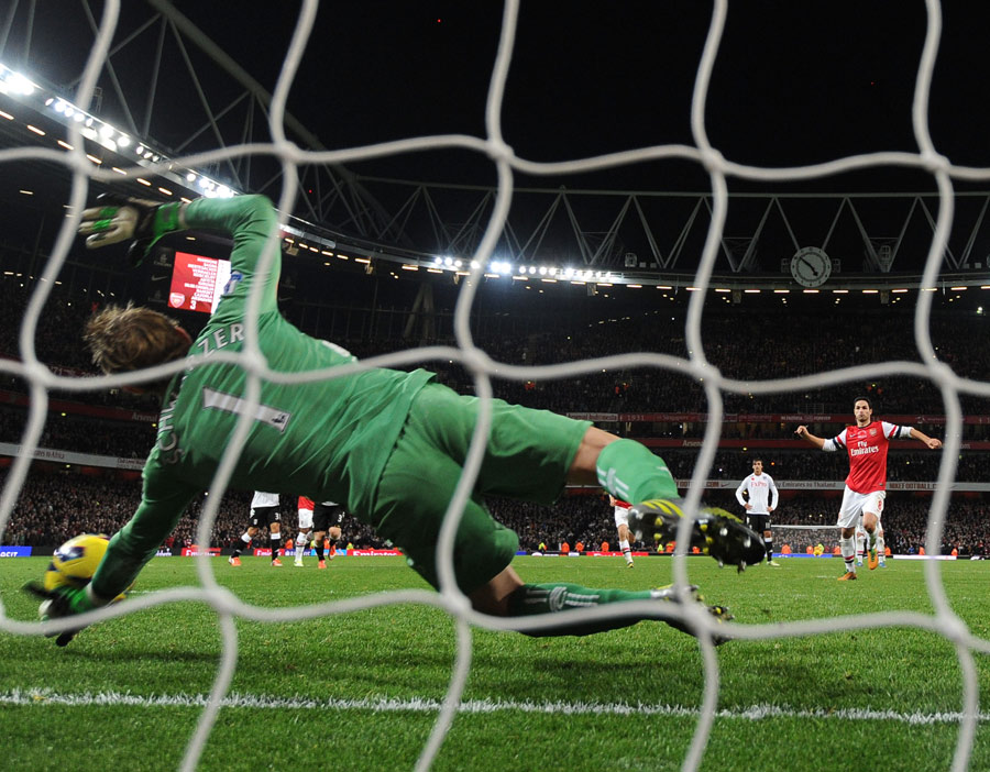 Mark Schwarzer dives to his left to save Mikel Arteta's penalty