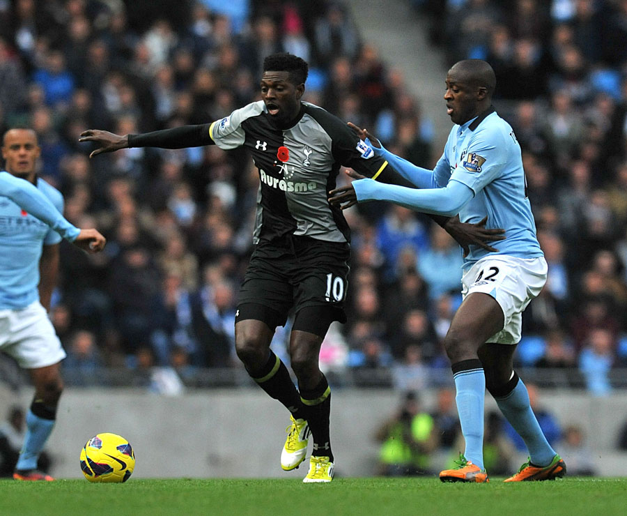 Yaya Toure and Emmanuel Adebayor battle for the ball