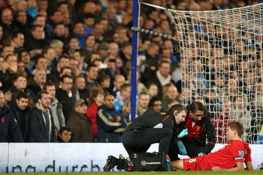 Steven Gerrard receives treatment on a knee injury