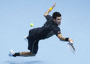 Novak Djokovic dives to reach the ball
