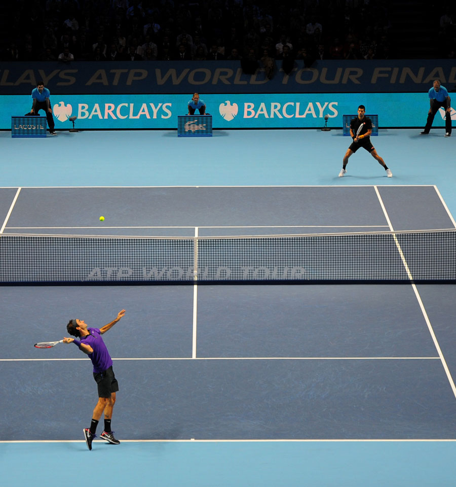 Roger Federer serves against Novak Djokovic