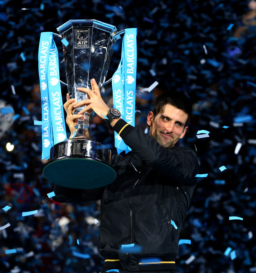 Novak Djokovic lifts the trophy as he celebrates victory