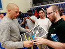 Georges St-Pierre signs autographs during UFC 145 open workouts