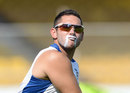 Tim Bresnan wears suncream on his face during a training session