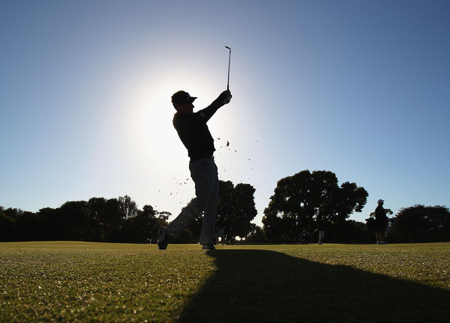 Ian Poulter plays a shot from the fairway during a practice round