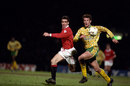 Eric Cantona and Chris Sutton battle for the ball
