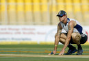 Kevin Pietersen inspects the pitch ahead of the Ahmedabad  Test