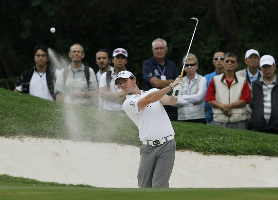 Rory McIlroy splashes out of a bunker