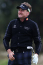 Ian Poulter reacts after hitting an approach