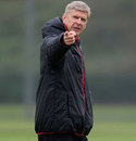 Arsene Wenger instructs his players at training