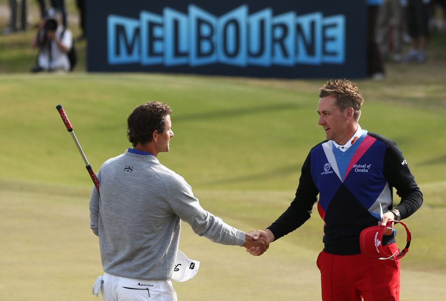 Ian Poulter and Adam Scott shake hands after their round