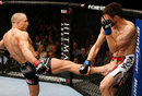 Georges St-Pierre throws a kick against Carlos Condit