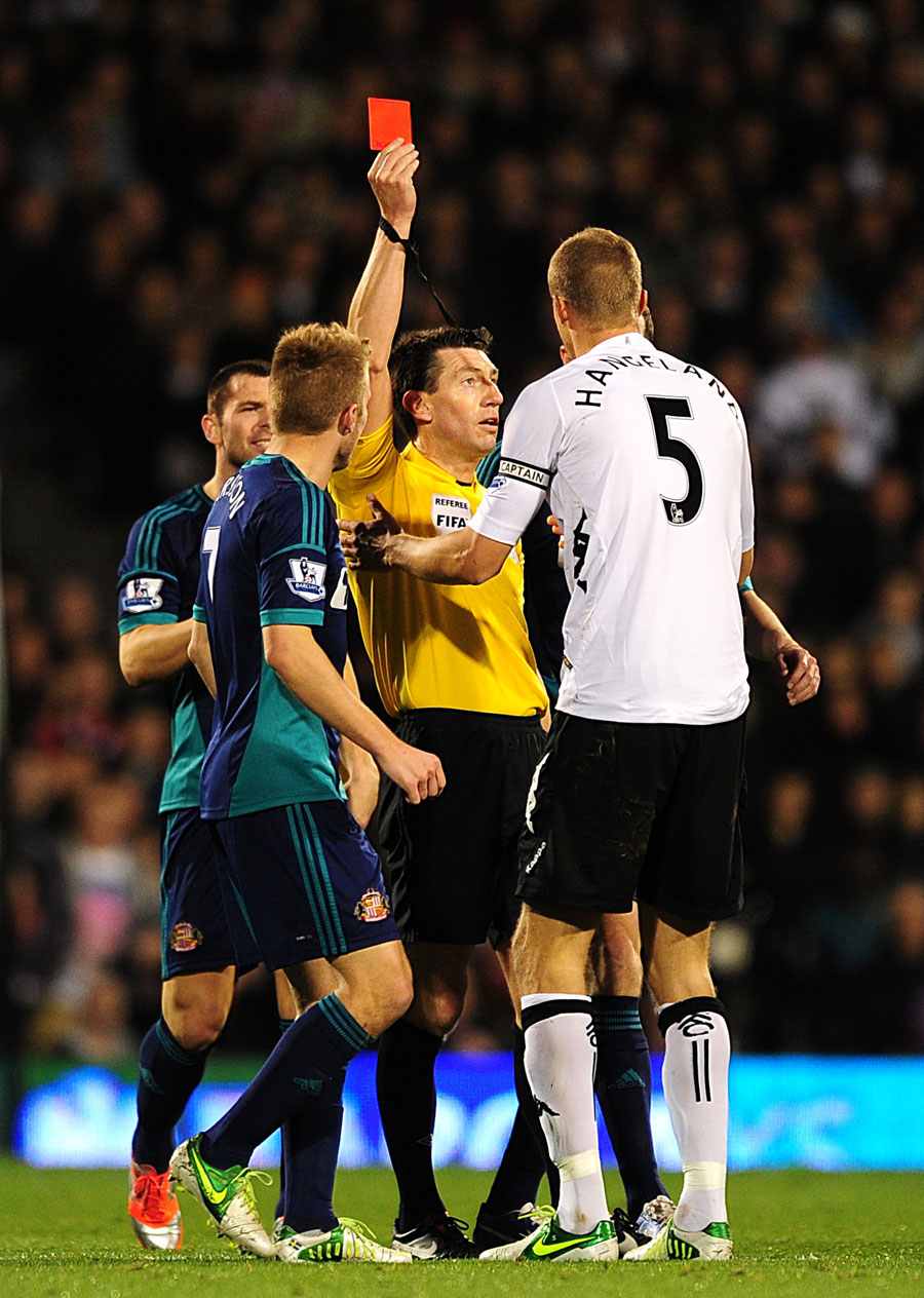 Brede Hangeland is shown a red card by Lee Probert