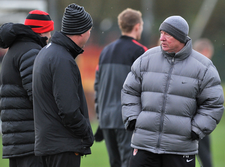 Sir Alex Ferguson chats to his coaches