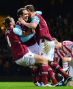Andy Carroll and Kevin Nolan celebrate with Joey O'Brien