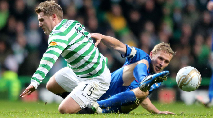Kris Commons tussles with Richie Foran