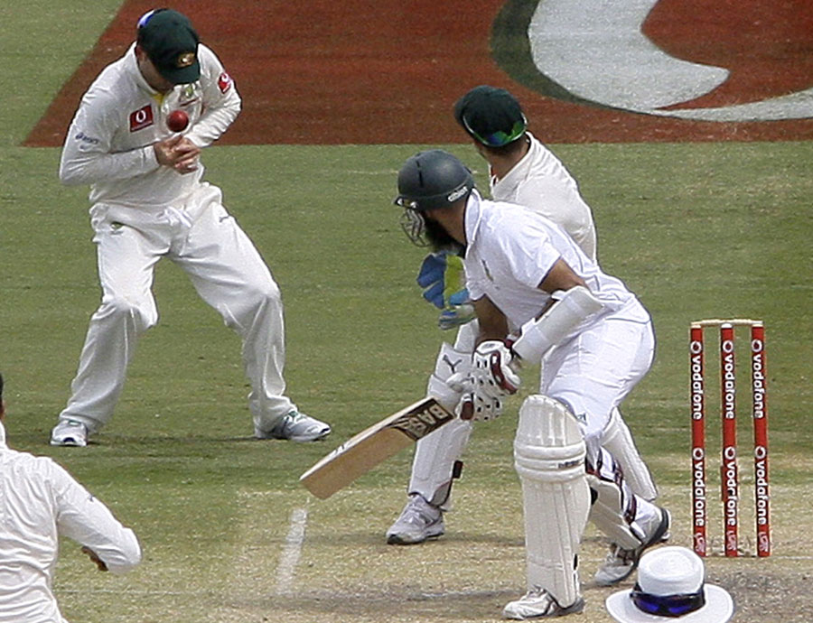 Michael Clarke juggles a ball before catching out South Africa's Hashim Amla