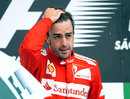 Fernando Alonso looks dejected on the podium