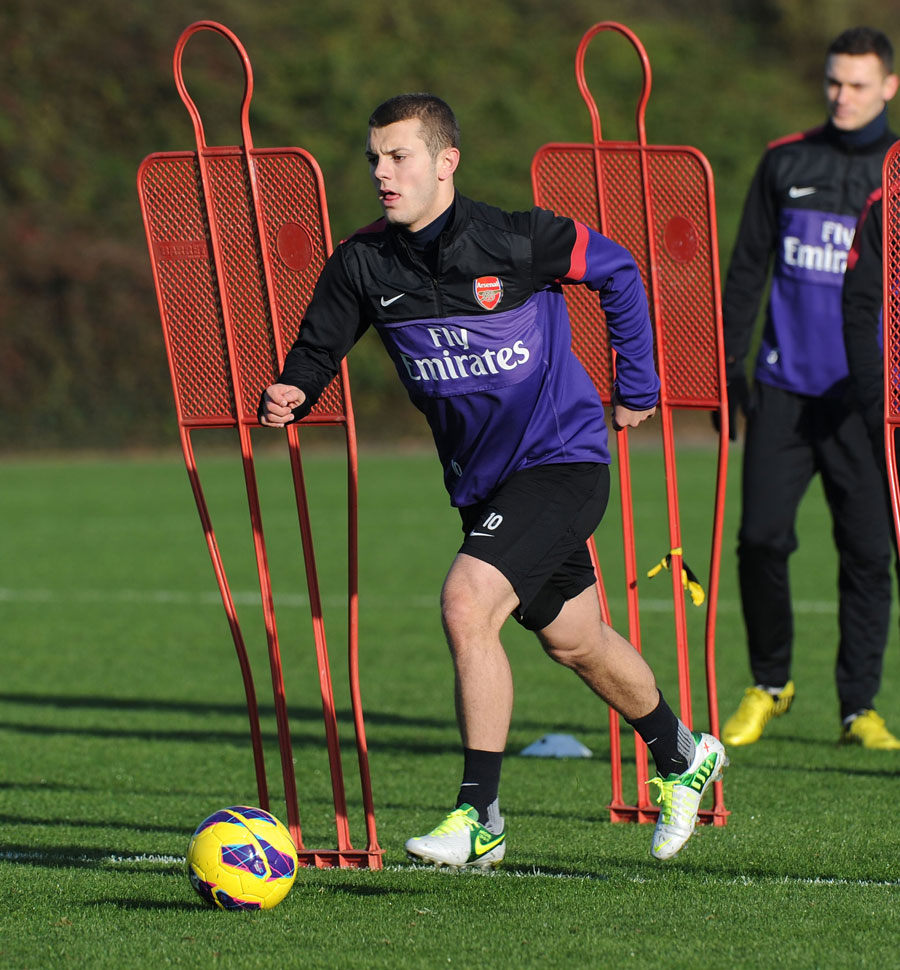 Jack Wilshere runs with the ball during a training session