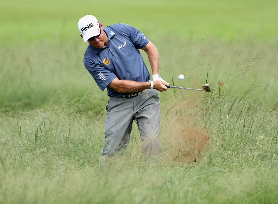 Lee Westwood hacks out of the rough