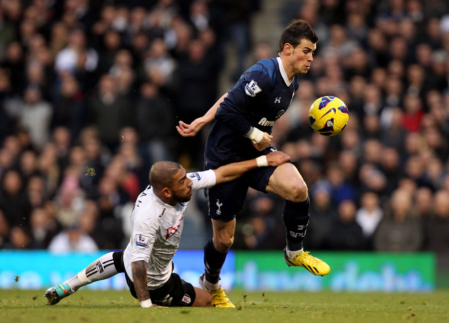 Gareth Bale is held back by Ashkan Dejagah
