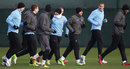 Manchester City players warm up for training