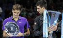 Novak Djokovic and Roger Federer inspect the trophies