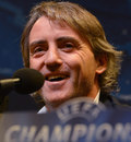 Manchester City boss Roberto Mancini talks to the press
