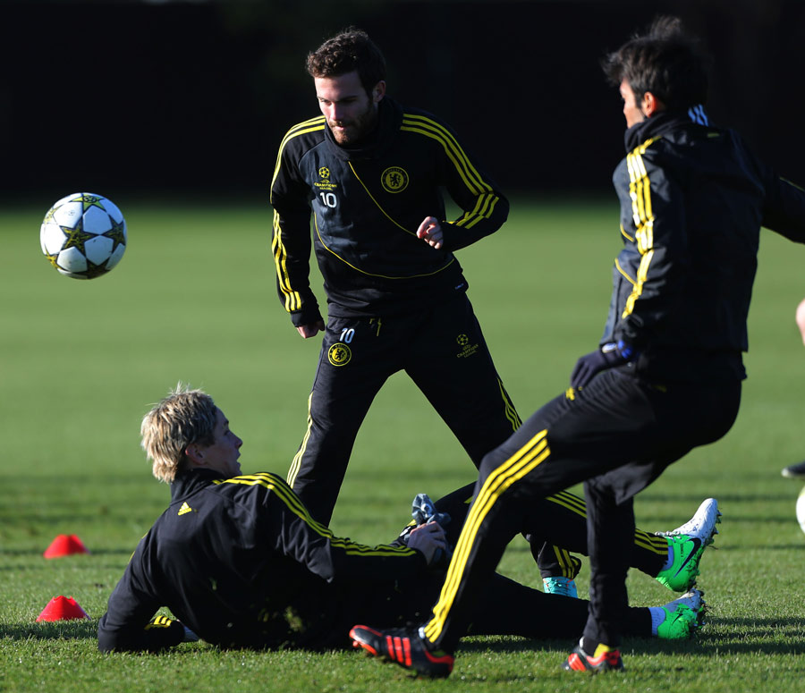 Chelsea's Juan Mata chips the ball over Fernando Torres in training