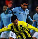 Carlos Tevez challenges Ilkay Guendogan for the ball