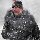 Alan Pardew faces the snow during a training session