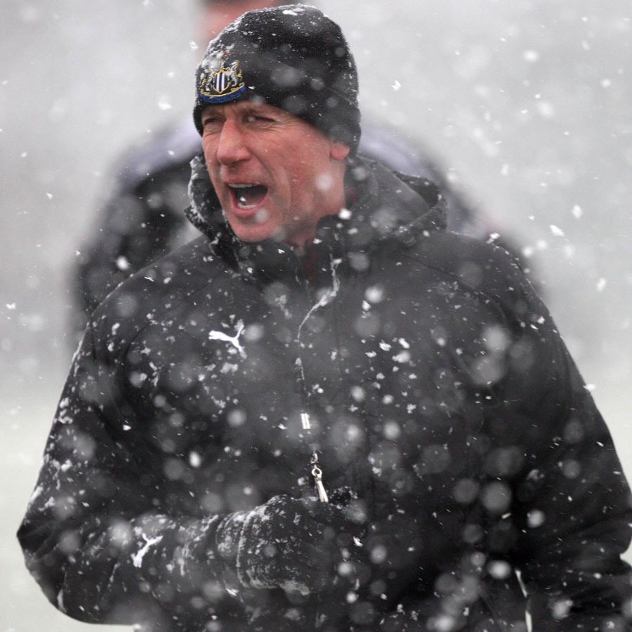 Alan Pardew faces the snow during a training session