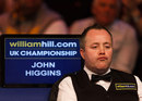 John Higgins looks on from his seat