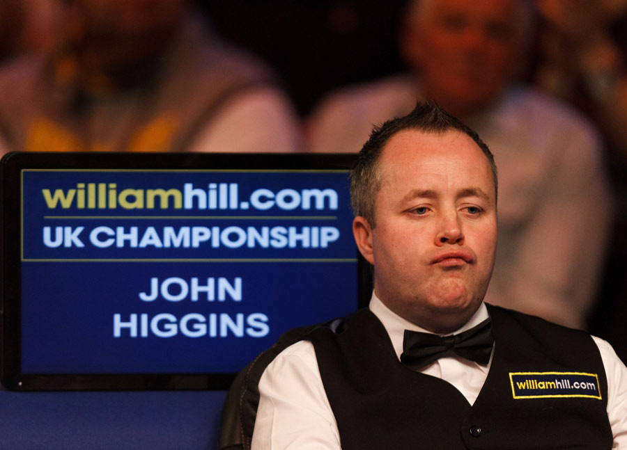John Higgins looks on from his seat
