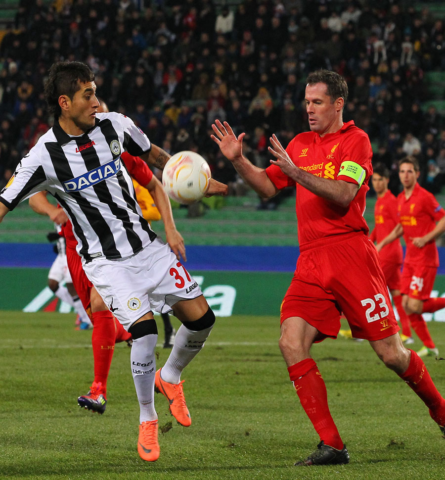 Roberto Pereyra and Jamie Carragher challenge for the ball