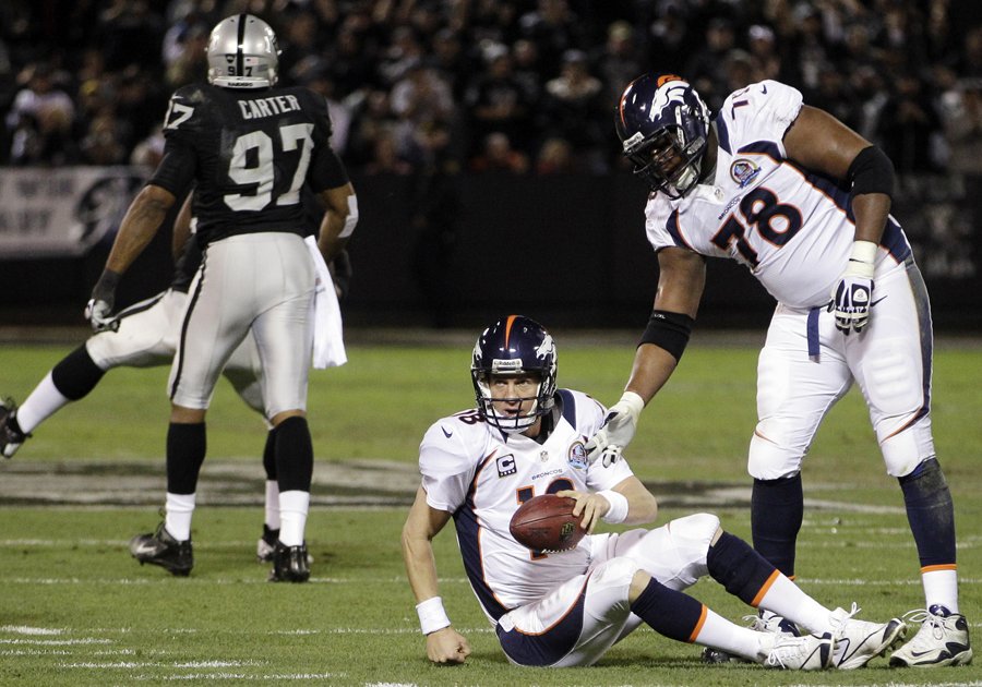 Peyton Manning is helped to his feet