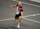 John McEnroe stretches for a backhand volley