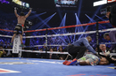 Juan Manuel Marquez celebrates as Manny Pacquiao is treated