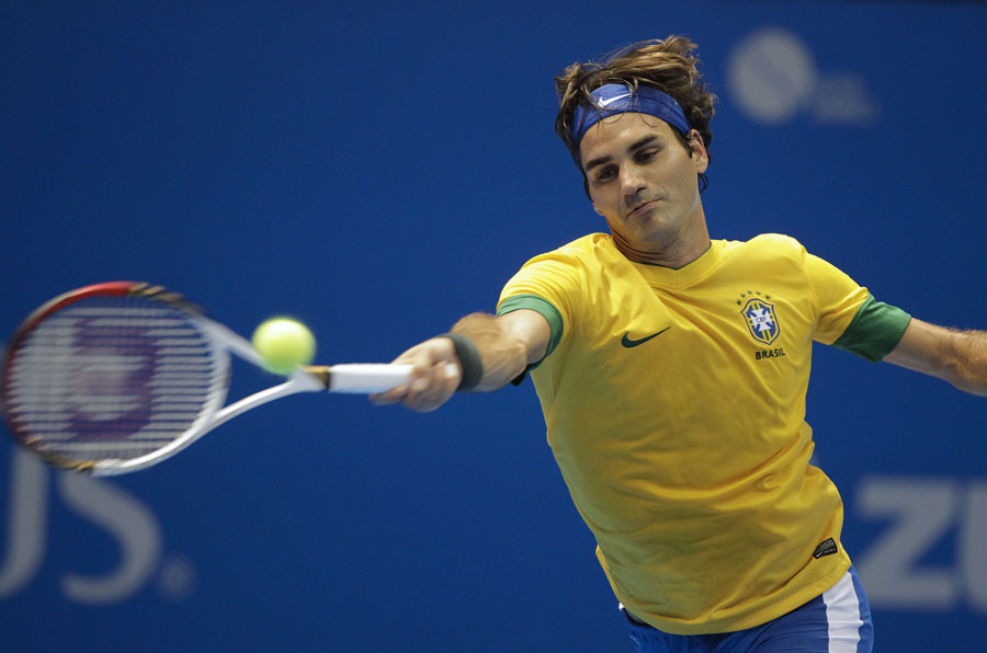 Roger Federer plays wearing a Brazilian football jersey