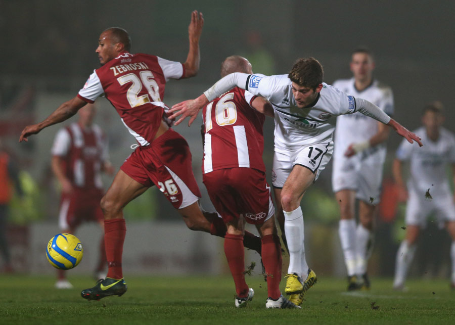 Will Evans of Hereford United loses out to Russ Penn and Chris Zebroski