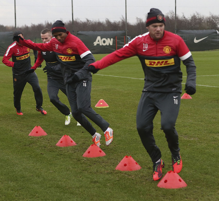 Tom Cleverley, Ashley Young and Wayne Rooney take part in a drill