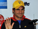 Roger Federer gestures during a press conference