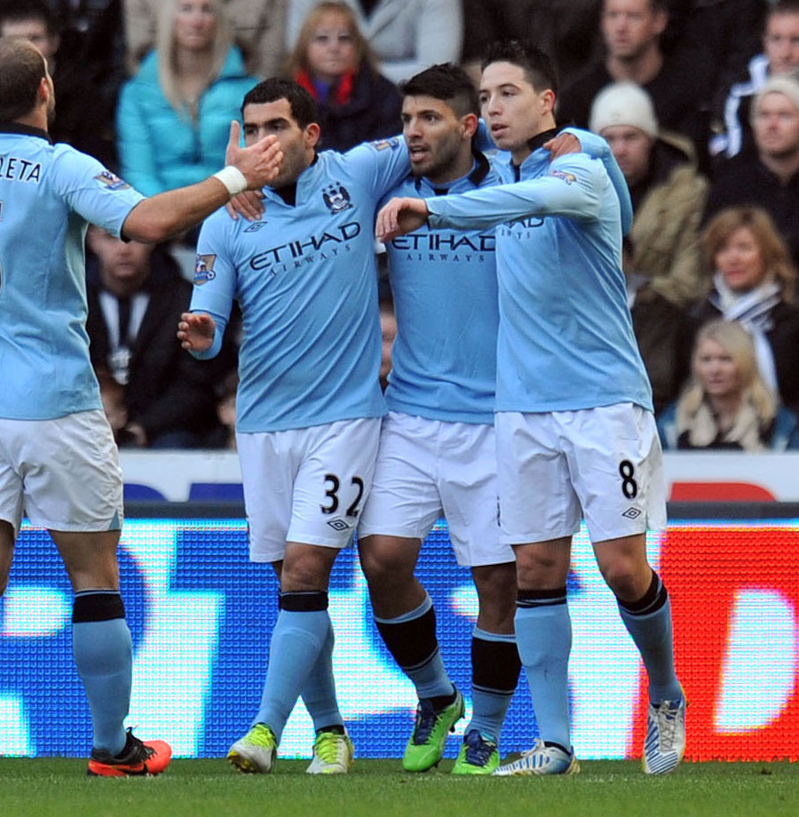 Sergio Aguero is mobbed by team-mates after scoring
